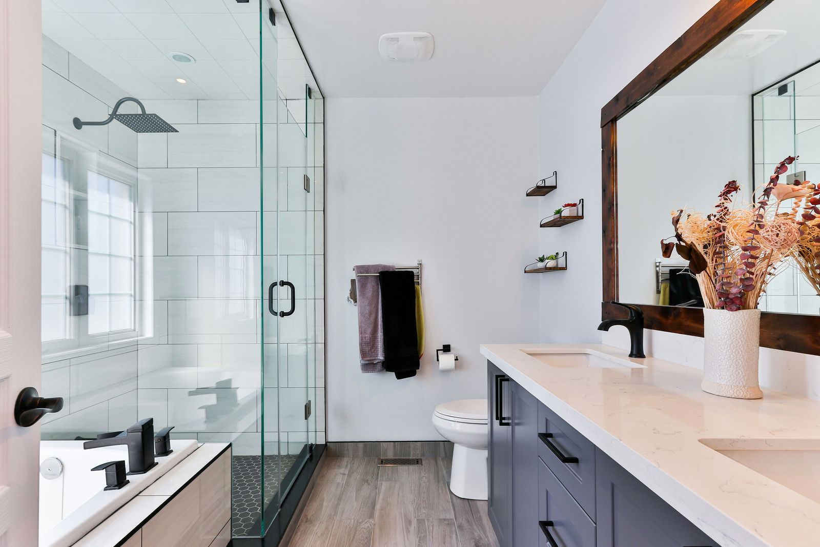 Remodelled white bathroom with a tiled walk-in shower, vanity and modern fixtures